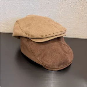 Detailed view of two Japanese style retro suede flat caps in coffee and brown colors