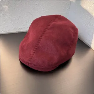 Detailed view of a retro burgundy suede newsboy cap with premium texture finish