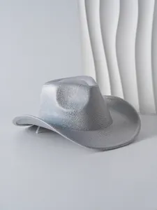 Detail view of a silver glitter cowboy hat with metallic texture and curved brim.