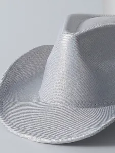 Close-up detail of a shiny silver cowboy hat showing metallic texture and woven fabric