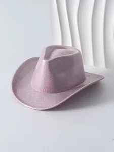 Stylish pink cowboy hat featuring a unique metallic woven texture and wide brim