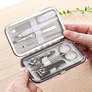 Portable 7-piece stainless steel manicure set with clippers and scissors in a pink case