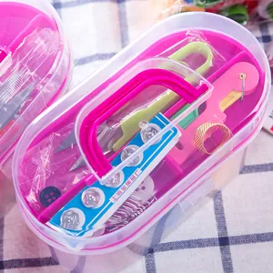 Compact portable household sewing kit in a small clear plastic box with pink handle