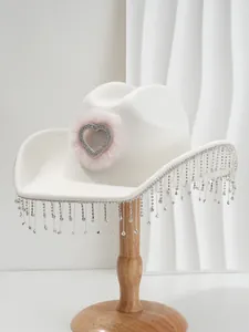 Elegant white bridal cowboy hat featuring shimmering rhinestone tassels and heart detail