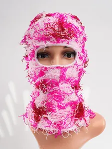 Macro view of the pink and red distressed knitted texture on a full face ski balaclava