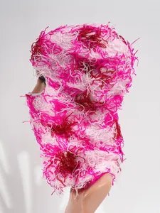 Detailed side view of a distressed pink camo knitted ski balaclava mask for winter