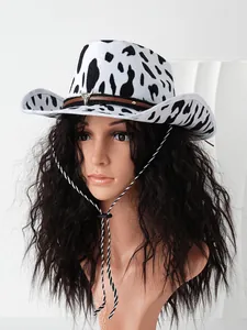Detailed shot of black and white cow print cowboy hat with a metallic bull head buckle