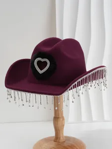 Detailed view of dark purple cowboy hat with rhinestone heart and crystal fringe