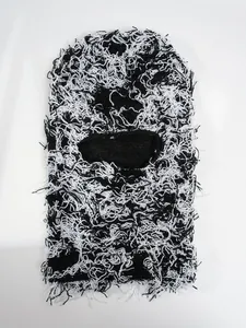 Close-up detail of distressed black and white camouflage knitted ski balaclava mask