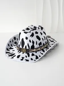 Detailed view of a cow print cowboy hat with a leather band and bullhead emblem