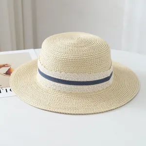 Close-up of French raffia straw hat with elegant lace and blue ribbon detail for summer.