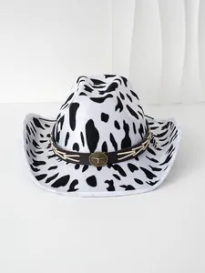 Close-up of black and white cow print cowboy hat with bull head metal ornament