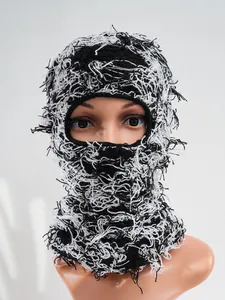 Detailed view of black and white distressed knitted balaclava with fringe textures