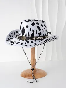 Detailed view of a black and white cow print cowboy hat with decorative bull head buckle