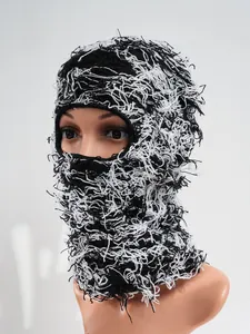 Detailed macro view showing the distressed knit texture of black and white ski balaclava