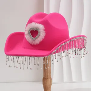 Vibrant hot pink cowboy hat featuring a rhinestone heart and shimmering tassel fringe
