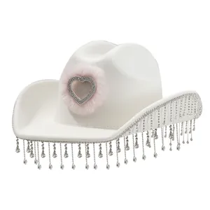 White bridal cowboy hat with pink furry heart and sparkling rhinestone fringe tassels.
