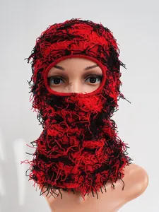 Close-up of red and black distressed knitted balaclava ski mask for winter protection
