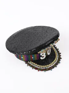 Dettaglio di un cappello da capitano di paillettes nere con strass colorati e numero 30 di perle