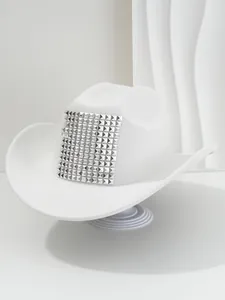 Detailed view of white western cowboy hat with large square silver pyramid studs decoration