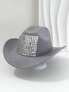 Detailed view of a gray western cowboy hat featuring bold 3D silver pyramid rivets on crown.