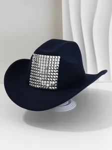Close-up of navy blue western cowboy hat featuring bold silver pyramid stud detailing