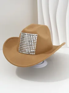Detailed view of silver pyramid studs on a tan Western cowboy hat for party fashion