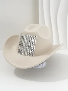 Detailed view of beige cowboy hat featuring a bold square of silver pyramid studs.