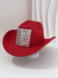Close-up of a red cowboy hat featuring large square silver rivet decorations for parties.