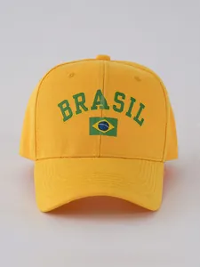 Close-up of Brazil flag print and green Brasil text on yellow cotton baseball cap