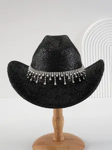 Detailed macro view of black glitter cowboy hat adorned with pearl and rhinestone fringe.