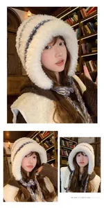 Cozy white plush earflap hat with blue braided ties shown in warm library setting