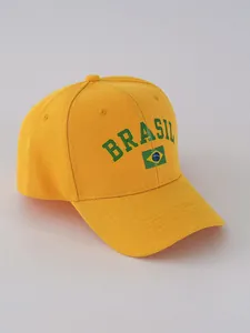 Detailed view of yellow Brazil themed baseball cap featuring green Brasil text and flag