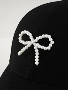 Vista macro dettagliata dell'elegante fiocco in perle bianche su cappellino nero