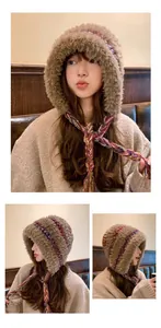 Warm plush earflap hat with colorful knitted accents and decorative braided chin ties