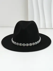 Detailed close-up showing the bohemian rhinestone eye band on a classic black felt fedora hat