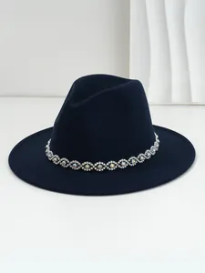 Detail shot of navy blue wool fedora hat with sparkling rhinestone eye patterned band