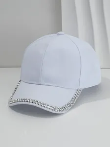 Detailed view of light blue baseball cap featuring silver metal stud embellishments