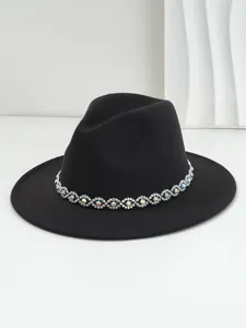 Detailed view of bohemian black fedora featuring shimmering rhinestone eye trim band.