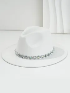 Detailed view of the crystal-encrusted bohemian eye-shaped band on a white fedora hat