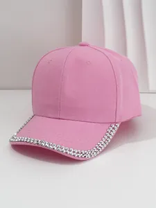 Detailed view of a pink vintage baseball cap with silver metal studs on the brim.