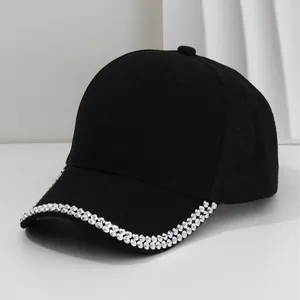 Stylish black baseball cap featuring silver metallic studs on the curved brim, unisex.