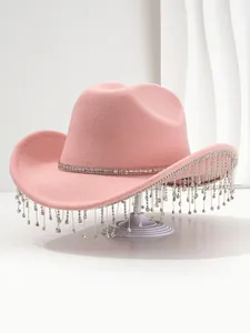 Detailed macro view of a pink felt cowboy hat featuring sparkling rhinestone tassel fringe