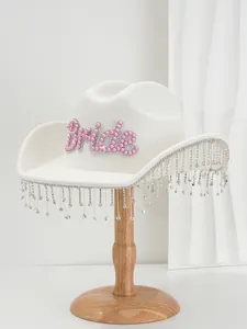 Detail of white wool hat with pink pearl Bride patch and sparkling rhinestone fringe