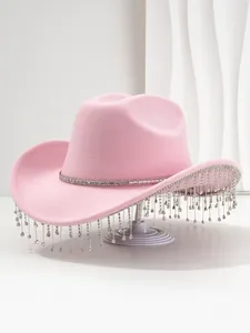 Detailed view of pink party hat featuring sparkling rhinestone trim and long crystal tassels