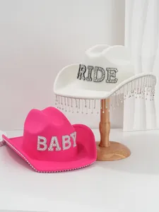 Close-up detail of white bridal cowboy hat with rhinestone BRIDE letters and fringe