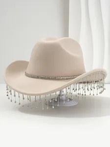 Close-up detail of a beige felt cowboy hat featuring sparkling rhinestone fringe