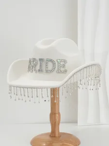 Close-up of white wool hat with rhinestone BRIDE letters and sparkling fringe