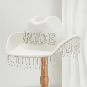 White felt cowboy hat featuring pearl BRIDE lettering and elegant rhinestone fringe.