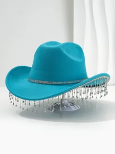 Detail of teal cowboy hat with sparkling rhinestone fringe for music festivals and parties